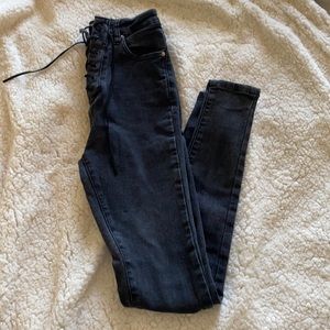 White fox lace up black skinny jeans